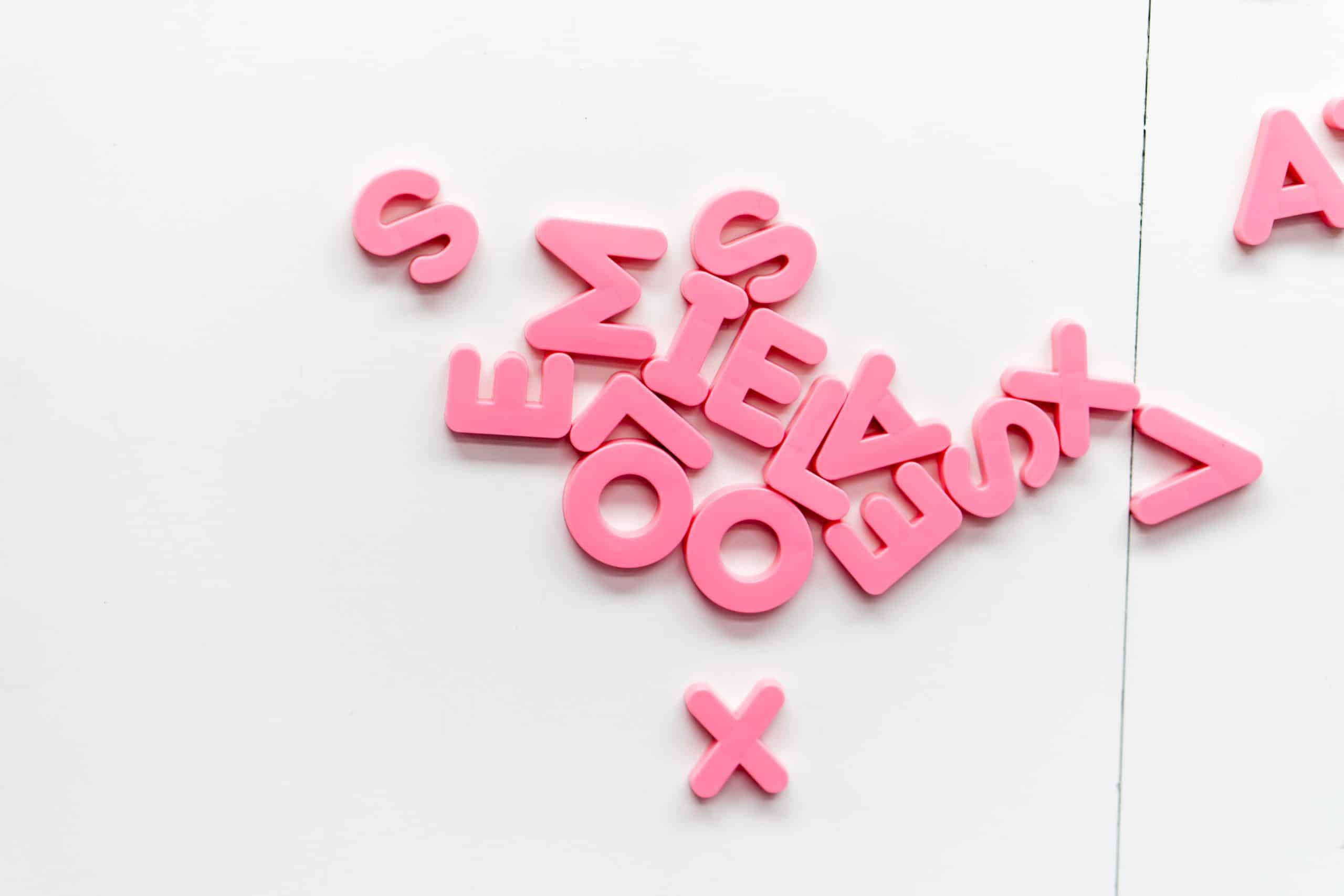 a pile of pink letters on a white background