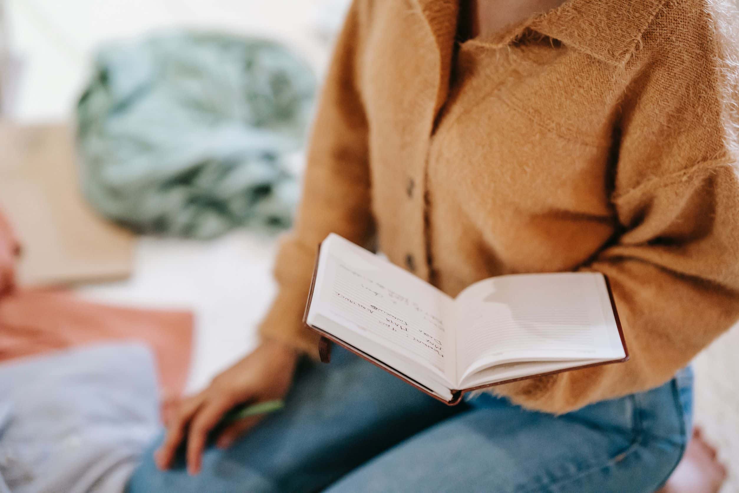 woman sitting with an open notebook